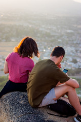 2 People hanging out on mount Rubidoux during Sunset in RIverside, California. USA