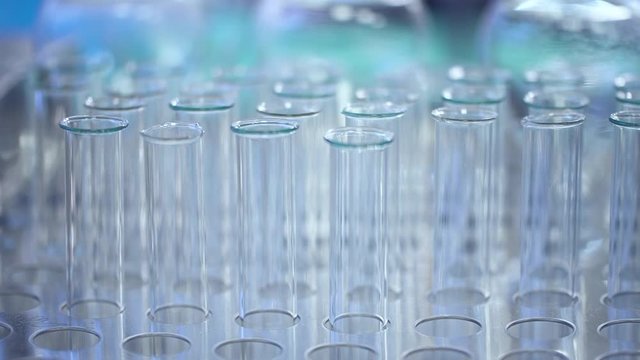 Glass test tubes for analysis in the laboratory Spbd. Close up. pharma laboratory for research. flasks in a row. concept sample, experiment, beaker. moving footage