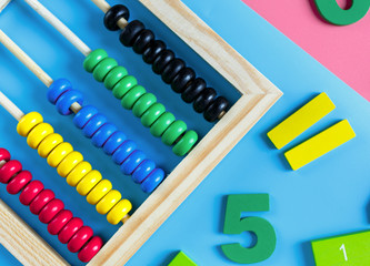 Colorful math fractions, numbers on blue pink white background. Interesting, fun mathematics for kids. Education, back to school concept	