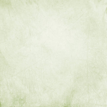 Abstract bright olive green stained paper texture with scratches background or backdrop. Empty old paperboard or grainy cardboard for decorative design element