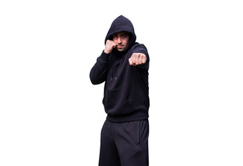 Naklejka na ściany i meble Young Caucasian Adult Man wearing black sweat pants and hoody is standing in a Fighting Stance and Punching.. Isolated on White Background. Perfect for image composite