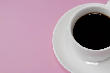 Minimalist white cup of coffee with plate on pink background with copy space on left. Pink background. Watercolor background. 