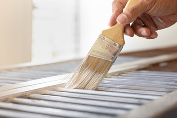 Man painting his home indoor. Brush and paint tools.