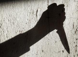 Shadow of the hand holding a knife