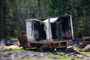 Fototapeta na wymiar Burnt and Vandalised Truck in a field. Taken in Squamish, British Columbia, Canada.