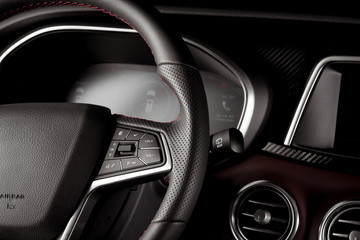 Obraz na płótnie Canvas Close-up steering wheel inside a new suv car with digital speedometer display