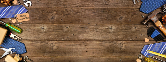 Happy Fathers Day gift tag with double side border of gifts, ties and tools on a rustic wood banner background. Top view with copy space.