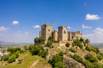 Fototapeta na wymiar Aerial Drone view of a beautiful castle in South of Spain with green fields in the background