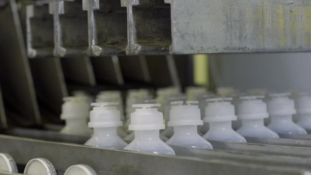 plastic bottles on sterilizer of Medical Solutions Conveyor, . Blow fill seal technology technique used to produce liquid-filled container on medical or food industrial factory. close up medical