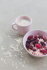 Oatmeal porridge in bowl topped with fresh berry