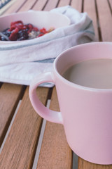 Oatmeal porridge in bowl topped with fresh berry