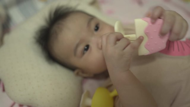 Baby boy using soothing teether 