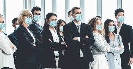 Confident business people with face mask protect from Coronavirus or COVID-19. Concept of help,...
