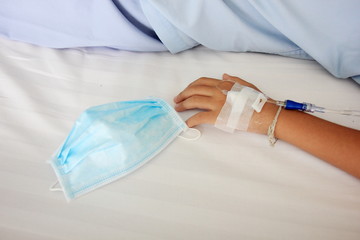 Fototapeta premium Close up child hand saline intravenous. Baby admitted at hospital. Health care and Medical equipment concept.