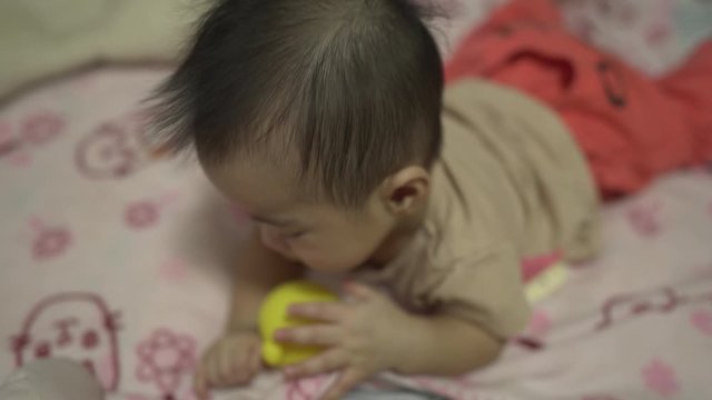 Baby boy using soothing teether 