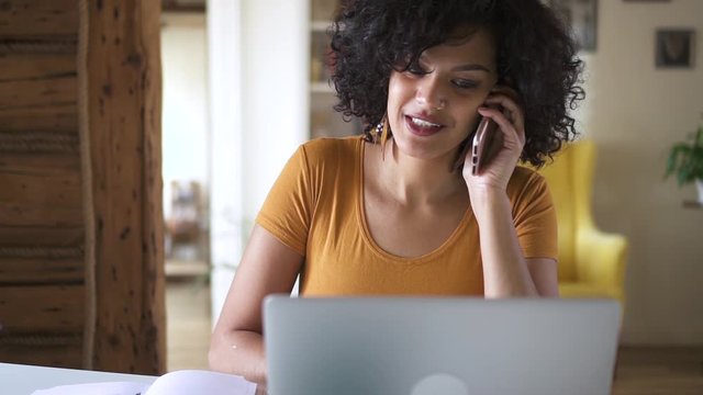 woman pick up phone when working at laptop in office or at home Spbd. consulting client, talking to friend ob quarantine. answering smartphone calll. conversation, business, communicate