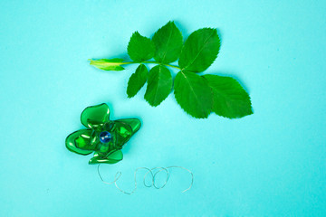 green leaves and artificial plastic flower, zero waste, concept of conservation and protection of...