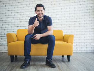 Happy handsome man showing thumbs up