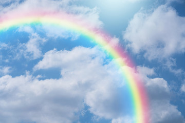 Rainbow in blue sky.