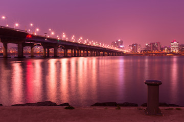 Fototapeta na wymiar Han river and Seoul city at night, viewed from Yeouido Hangang Park of Seoul, South Korea, long exposure photography for smooth water 