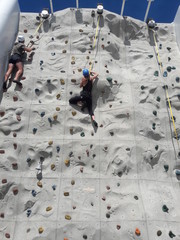 Woman on rock climbing wall on cruise ship