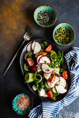 Fototapeta na wymiar Healthy vegetable salad on rustic background