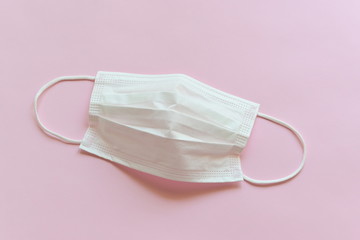 medical hygiene face mask on pink background