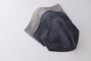 heap of face mask handmade from fabric cotton cloth for sale, objects isolated on white background