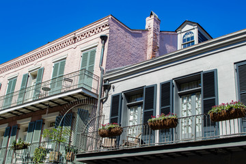 Balconies Featuring Flower Baskets Overlook the Streets below in the French Quarter of New Orleans, Louisiana, USA (Picture Taken from Public Street)