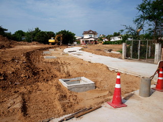 Site of construction of a road drainage system in the community On the house background and blue...