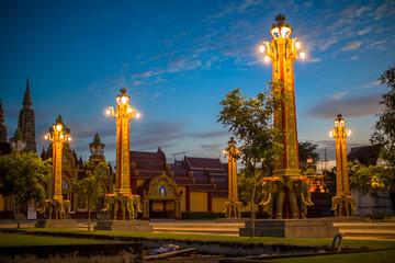 Fototapeta na wymiar Wat Mahathat Wachiramongkol Former name (Wat Bang Tong) is located Krabi,The environment is rubber plantation. And oil palm plantation, a towering pagoda is beautiful, tourists are always watching.
