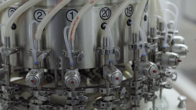 glass bottles on a medical solution conveyor at filling station close up medical industry
