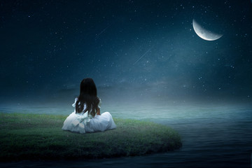 little girl sitting on the moon