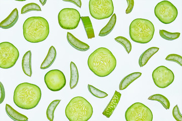 Slices of fresh green aloe vera and cucumber on white background.