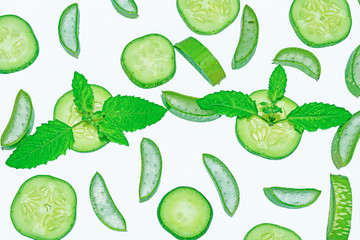 Slices of fresh green aloe vera and cucumber on white background.