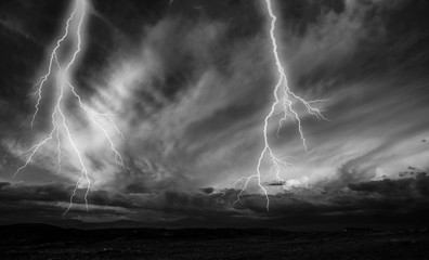 Lightnings during a thunderstorm at night. Black and white image