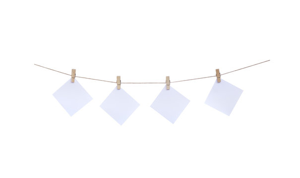 Wood clothes pins with paper hanging on rope isolated on white background , clipping path