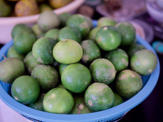 Green lime lemons in the basket