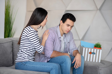 Young couple sitting at home on the couch.