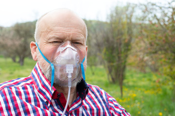 Senior man with oxygen mask outdoor