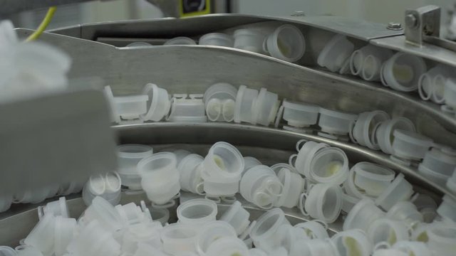 plastic caps on Medical Solutions Conveyor . Blow fill seal technology technique used to produce liquid-filled container on medical or food industrial factory. medical industry
