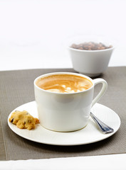 Coffee, white coffee, latte coffee. A cup of cappuccino coffee served with cookies.