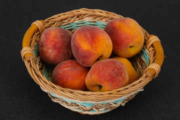 Peach heap in the wooden basket