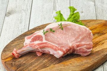 Raw pork bone steak over wooden