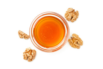 Honey with walnuts isolated on white background