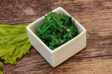 Green Chuka Seaweed Salad Isolated on White Background Top View. Wakame Sea Kelp Salat