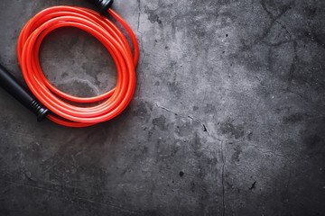 Jump rope. Physical education. Sports exercise equipment. Rope exercises routine. Pink jump rope phone with a stopwatch and water on the table.