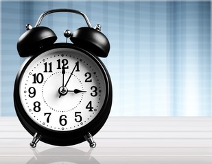 Classic old table alarm clock on the desk