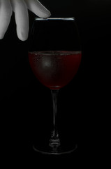 Red wine in a glass on a black background. Red wine. Photo in dark key.
