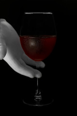Red wine in a glass on a black background. Red wine. Photo in dark key.
